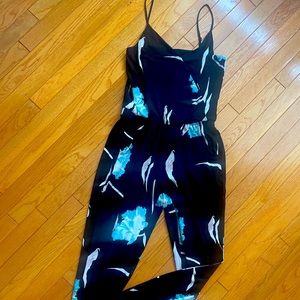 versatile sleeveless black romper w front pockets